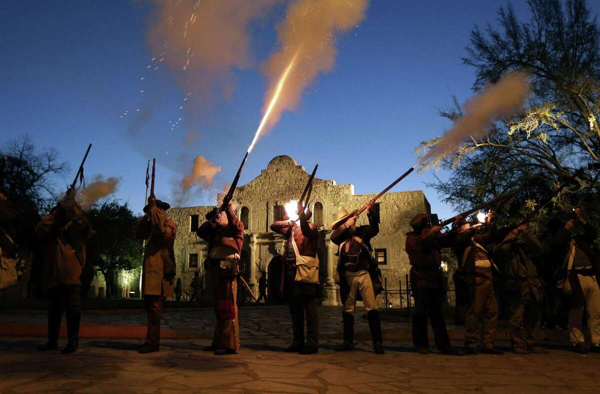Members of the San Antonio Living History Association fire muskets as they take part in a pre-dawn memorial ceremony to remember the 1836 Battle of the Alamo and those who fell on both sides, March 6, 2013, in San Antonio.
