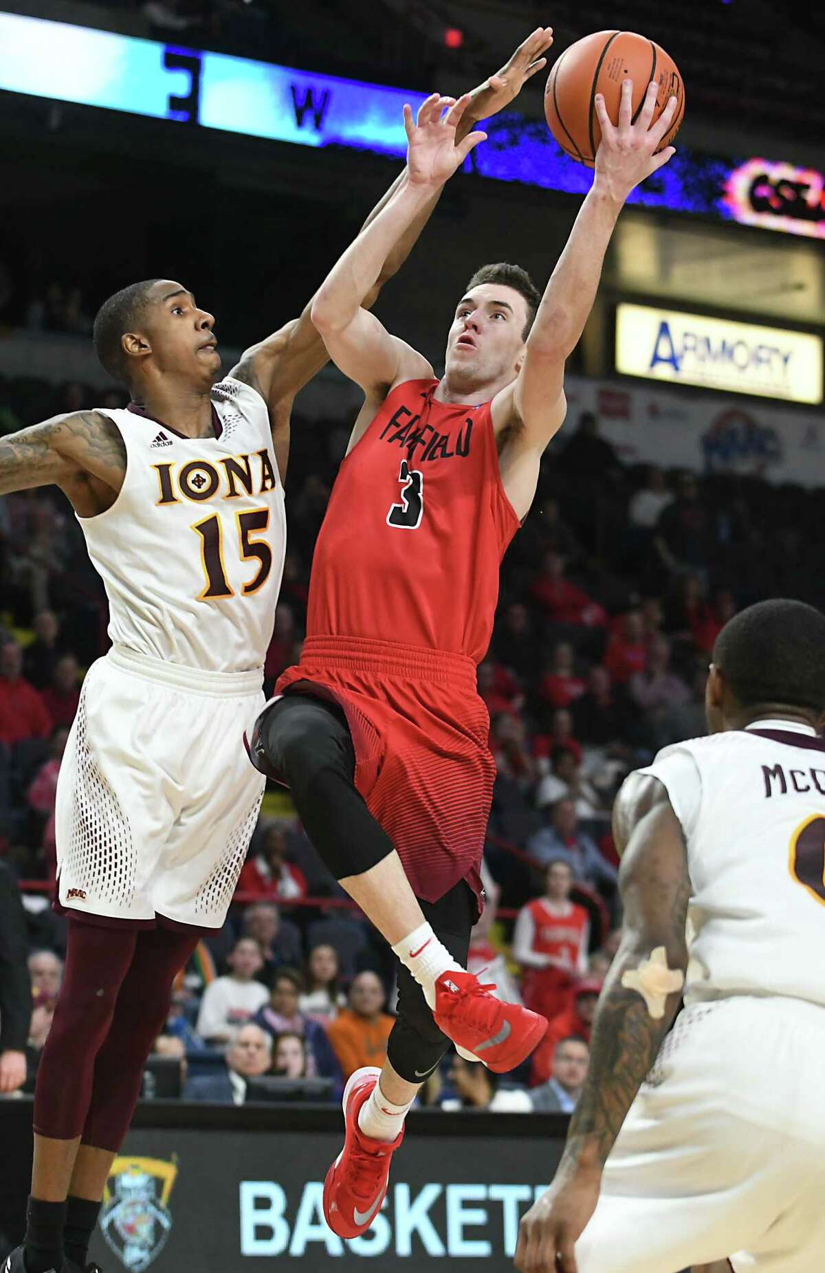 Fairfield's Tyler Nelson drives to the net guarded by Iona's Deyshonee Much in the Metro Atlantic Athletic Conference Tournament's championship game at the Times Union Center on Monday, March 5, 2018 in Albany N.Y. (Lori Van Buren/Times Union)