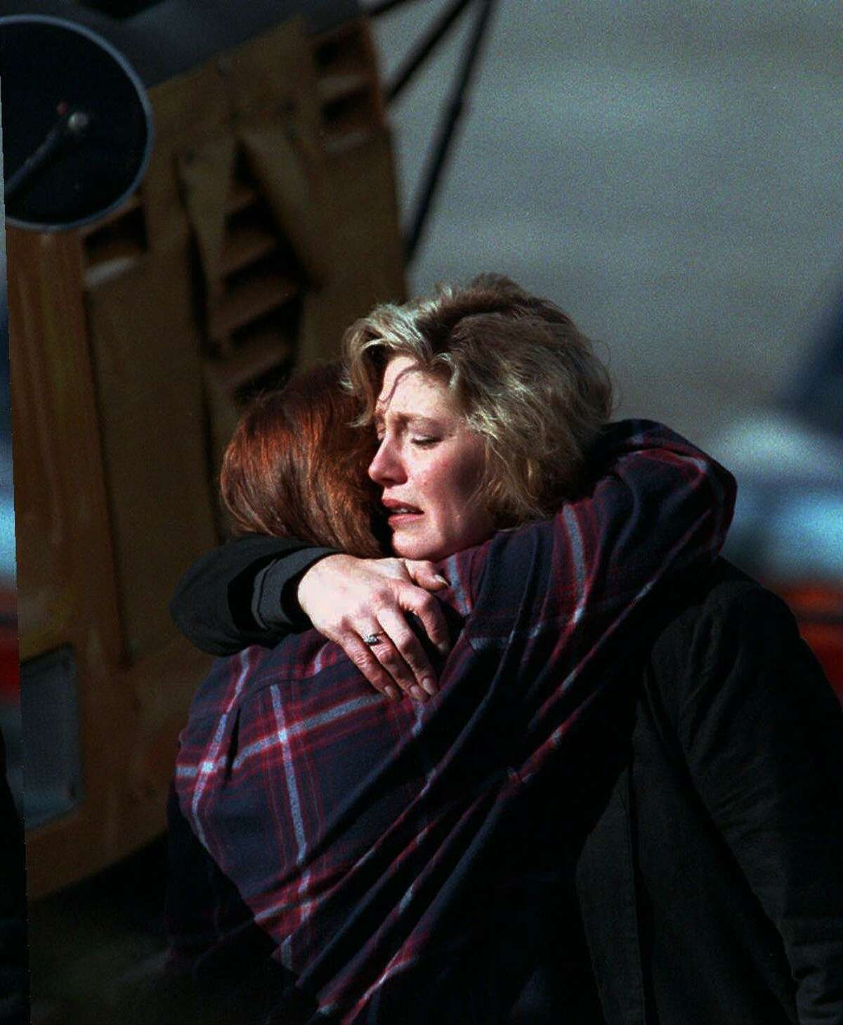 State lottery workers comfort each other outside Connecticut Lottery headquarters in Newington on March 6, 1998, after a lottery employee shot four people to death and then turned the gun on himself.