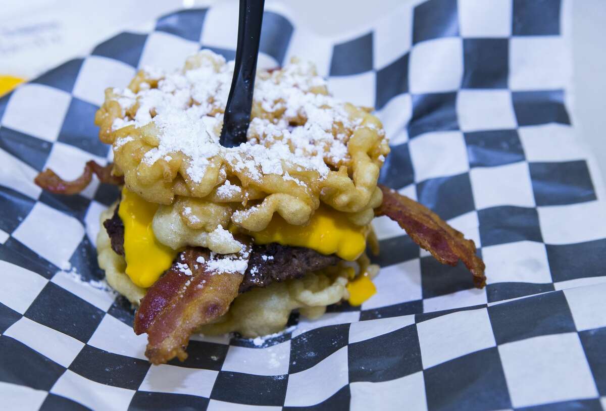 A bacon cheeseburger with a funnel cake bun during the judging of the Gold Buckle Foodie Awards in the Main Club of NRG Center, Monday, Feb. 26, 2018, in Houston. Judges tasted food that is available to the general public throughout the carnival and rodeo in several categories from "best dessert" to "most creative."
