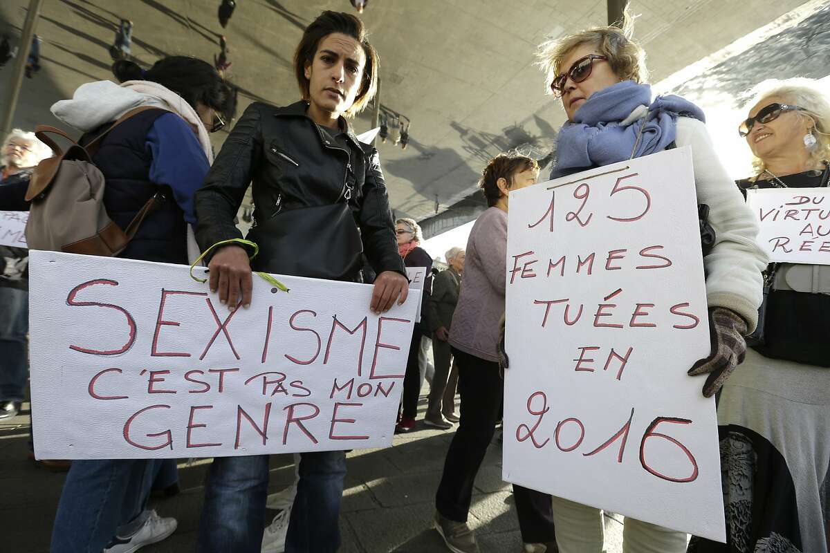 FILE - In this Oct. 29, 2017 file photo, demonstrators hold placards reading "Sexism, that is not my gender" and "125 women killed in 2016", right, during a demonstration against sexual abuse and harassment across the country under the #MeToo movement, in Marseille, southern France. Perhaps no country has had more complex reaction to #MeToo than France - long identified as a haven for romance. The government is preparing new legislation on sexual violence and harassment, and some lawmakers want to impose fines for sexist catcalls. Yet despite sexual misconduct allegations against several prominent men, they haven't lost their jobs or reputations. Meanwhile, French feminists ranks have experienced divisions. (AP Photo/Claude Paris, File)