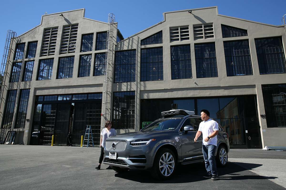 From left: Uber test operators Michelle Ortega and Robert Phung get out of the Volvo XC90 outside the Uber Advanced Technologies Group headquarters at Pier 70, Tuesday, March 6, 2018, in San Francisco, Calif.