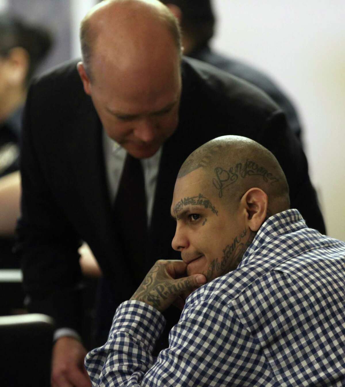 Gabriel Moreno, right, looks Tuesday, March 6, 2018 around the courtroom during a break in his murder trial. Moreno is accused in the beating and dismemberment of Jose Luis Menchaca in 2014.