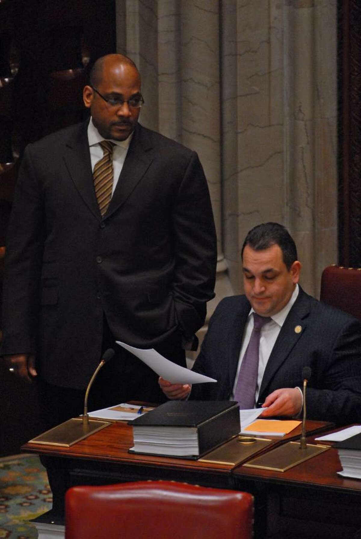 John L. Sampson, Democratic Conference Leader of the New York State Senate, left, stands next to fellow Democrat, State Senator Hiram Monserrate, right, while the Senate was gavelled into session for a short time Monday afternoon in the Capitol in Albany, NY, November 16, 2009. (Philip Kamrass / Times Union)