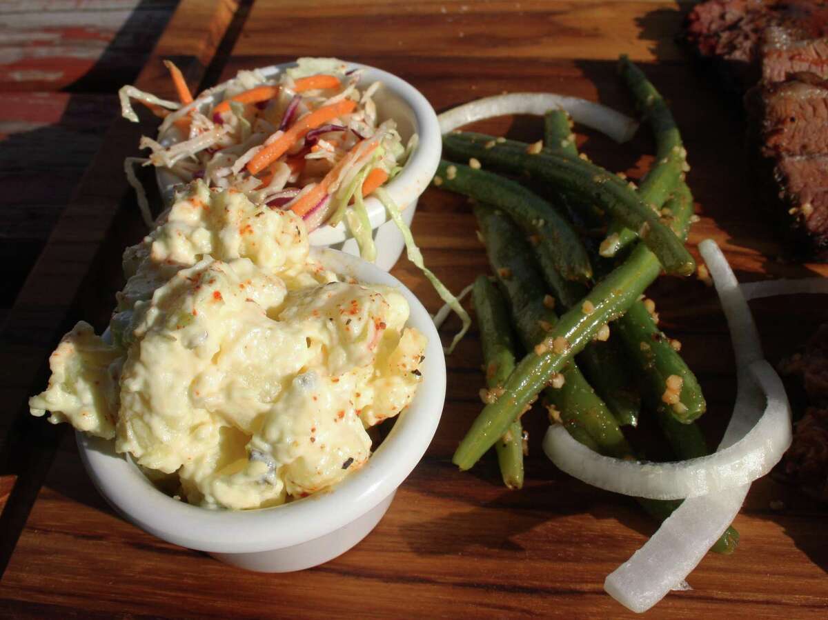 Sides at Bushwood BBQ include potato salad, cole slaw and green beans that are garden fresh and are coated with minced garlic. Chips and pinto beans are also available for $3 per single serving.