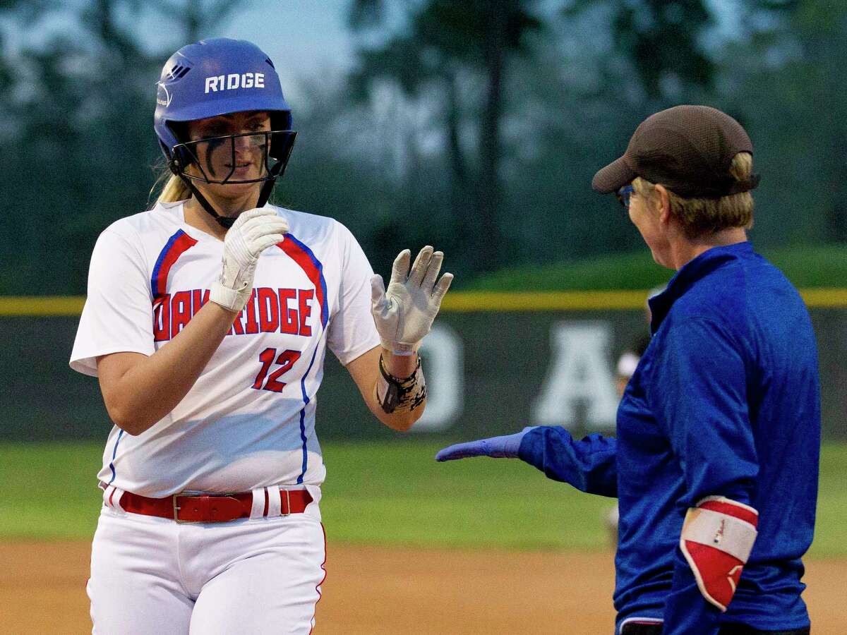 Oak Ridge's Ashley Crawford gets a high-five after hitting an RBI single during the first inning of a District 12-6A high school softball game, Tuesday, March 6, 2018, in Shenandoah.
