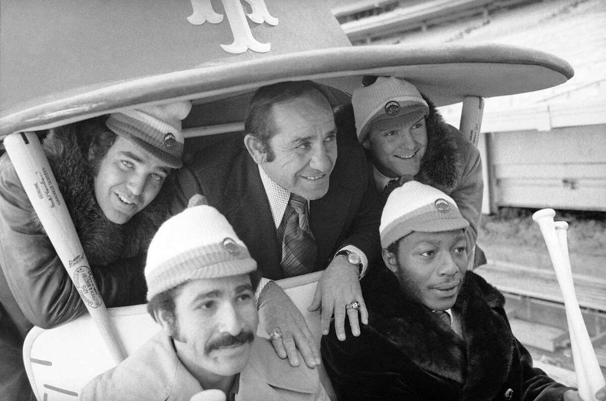 FILE - In this January 1973 photo, New York Mets manager Yogi Berra, center, poses in the team cart at Shea Stadium in New York with four who signed with the baseball team earlier in the day. They are, back row and from left: Ed Kranepool, Berra, and Tug McGraw. Front row, from left: Felix Millan and John Milner. Cleon Jones also signed, but was not present for the picture session. Bullpen buggies are rolling back, and Cleveland Indians manager Terry Francona is positively bug-eyed about the prospect. "I love it. I love it. I love it," he said Tuesday, March 6, 2018. Nearly a quarter-century since relievers stopped catching rides to the mound, the bullpen cart will become the latest retro feature to make a return to the big leagues. (AP Photo, File)