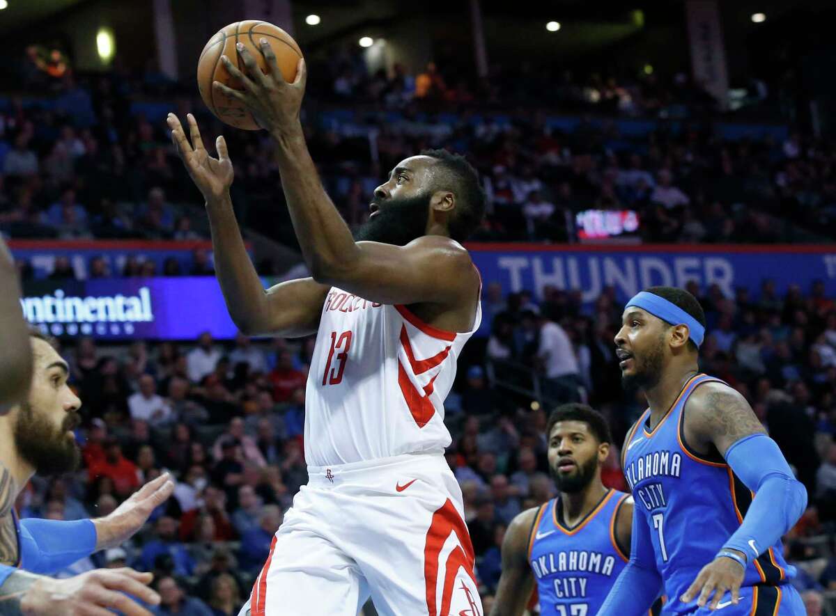 Houston Rockets guard James Harden (13) goes up for a shot between Oklahoma City Thunder center Steven Adams, left, forward Paul George (13) and forward Carmelo Anthony (7) in the first half of an NBA basketball game in Oklahoma City, Tuesday, March 6, 2018. (AP Photo/Sue Ogrocki)