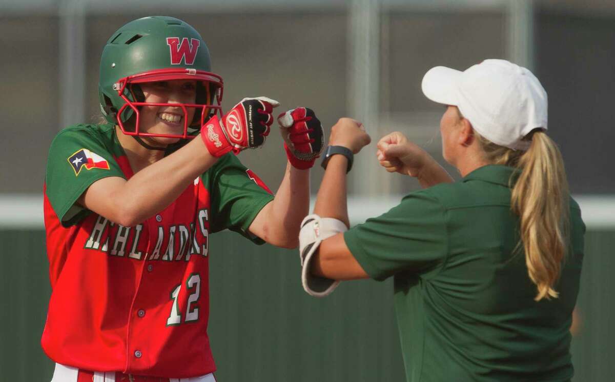 FILE - Skylar Stockton (12) of The Woodlands gets a double fist-bump from first base coach Paula Miller after hitting a single during the second inning in Game 1 of a Region II-6A quarterfinal series Thursday, May 11, 2017, in Madisonville. Stockton scored the winning run for the Lady Highlanders on Tuesday against Montgomery.