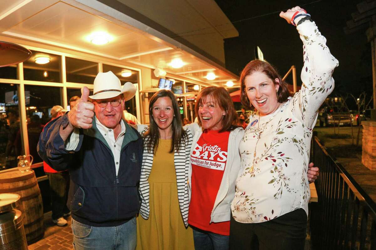 From the left, Mark Keough, Melisa Miller, Kristin Bays and Melanie Bush celebrate together as election results pour in on Tuesday, March 6, 2018, at Woodson's.