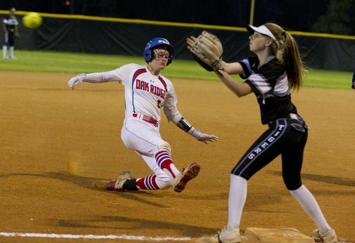 Sam Graeter #13 of Oak Ridge beats the tag from Conroe third baseman Makinsey Exley (4) during the first inning of a District 12-6A high school softball game, Tuesday, March 6, 2018, in Shenandoah.