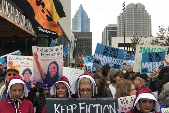 Sacramento’s Handmaids Coalition stand on the front lines as protesters gather outside of the Sawyer Hotel Wednesday, March 7, 2018 in Sacramento, Calif. ahead of U.S. Attorney General Jeff Session’s expected announcement regarding sanctuary jurisdiction.