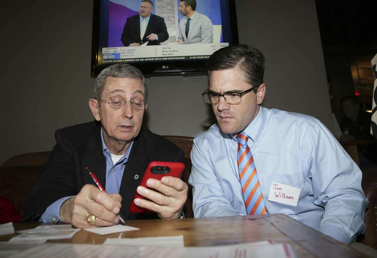 Jerry Patterson looks over early results with volunteer Jon Williams as he holds an election night watch party at the Red's Porch restaurant on Lamar Blvd. in Austin on March 6.
