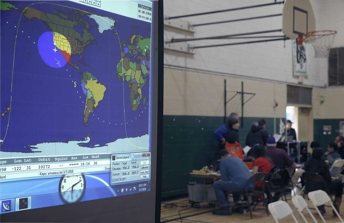 A map pinpointing the location of the International Space Station is projected on the screen.