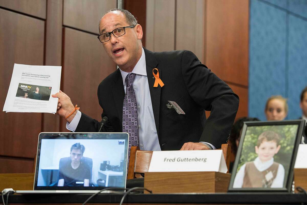 Fred Guttenberg, the father of 14-year-old Jaime Guttenberg who was killed at Stoneman Douglas High School in Parkland, Florida, holds up an print out of an National Rifle Association (NRA) ad as he pleads with Democratic senators to do something about gun violence during a Democrat meeting to hear testimony from survivors of gun violence and family members who want Congress to take swift action to strengthen US gun laws, on Capitol Hill in Washington, DC, on March 7, 2018. / AFP PHOTO / JIM WATSONJIM WATSON/AFP/Getty Images
