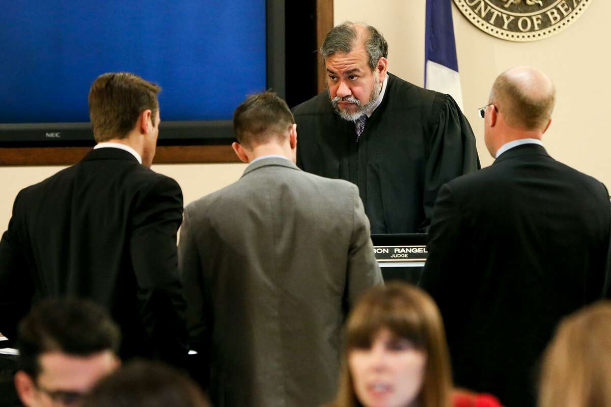 Prosecuting attorneys Josh Somers (from left) and Matthew Ludowig speak to Judge Ron Rangel with defense attorney Albert Gutierrez, Jr. about a question from the jury during the murder trial of Gabriel Moreno in the 379th state District Court on Wednesday, March 7, 2018. Moreno is one of three people accused of killing Jose Luis Menchaca, who was beaten with aluminum bats, suffocated and dismembered in 2014. MARVIN PFEIFFER/mpfeiffer@express-news.net