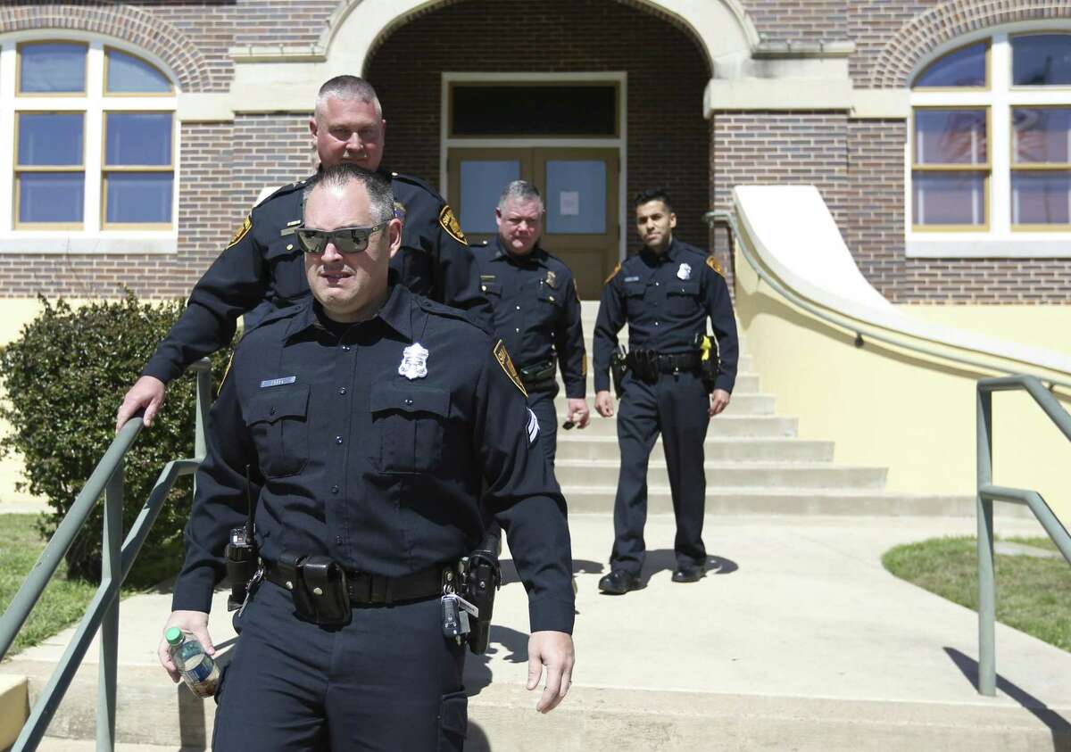 San Antonio Police Department Detective Brent Lively, front, leaves the Atascosa County Courthouse in Jourdanton Wednesday, March 7, 2018 after testifying in the capital murder trial of Shaun Ruiz Puente, 36, who is accused of shooting and killing SAPD Officer Robert Deckard during a multi-county chase Dec. 8, 2013.