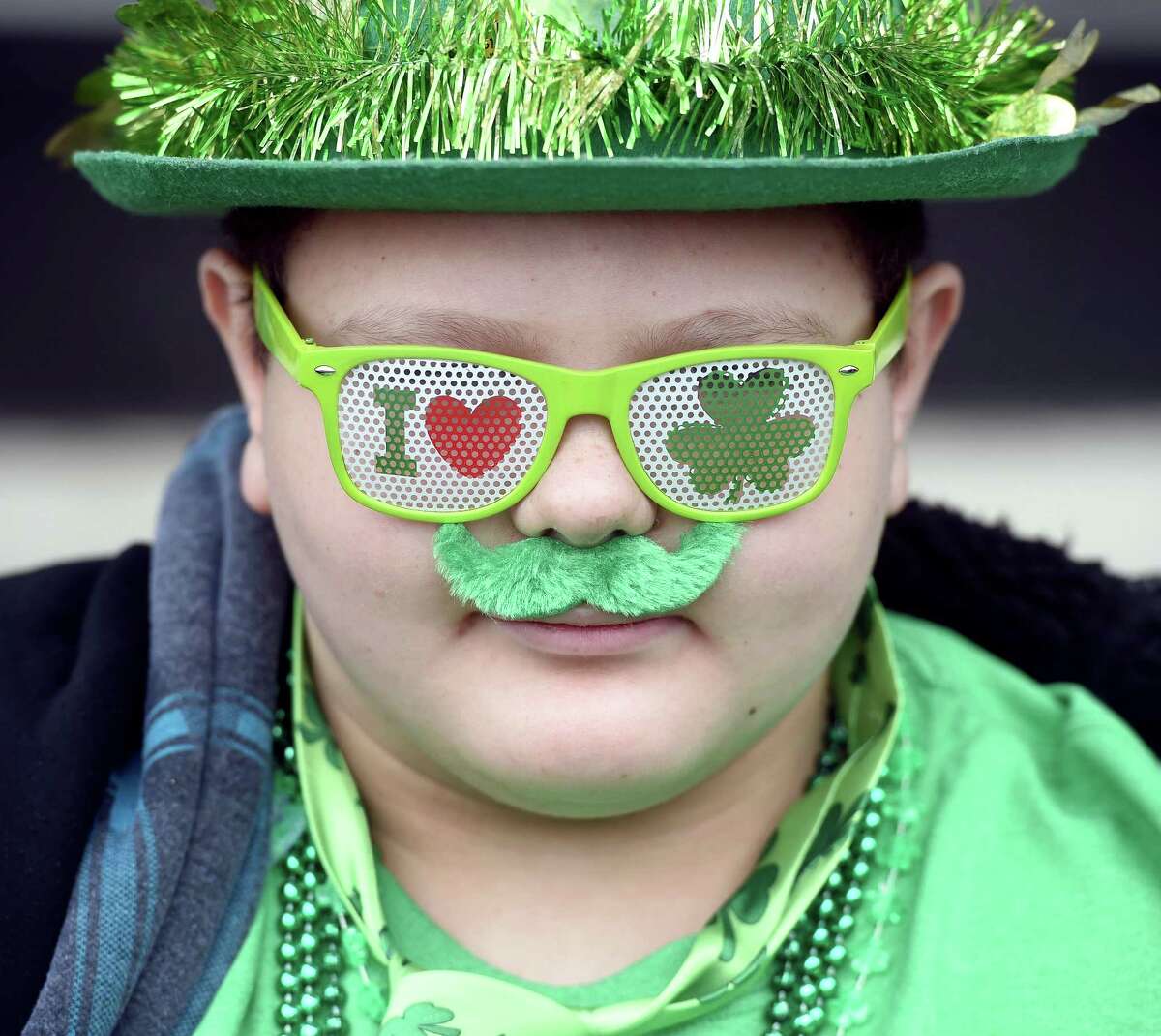 Luis Roman, 11, of New Haven watches the annual Greater New Haven St. Patrick's Day Parade on Chapel St. in New Haven in 2016.