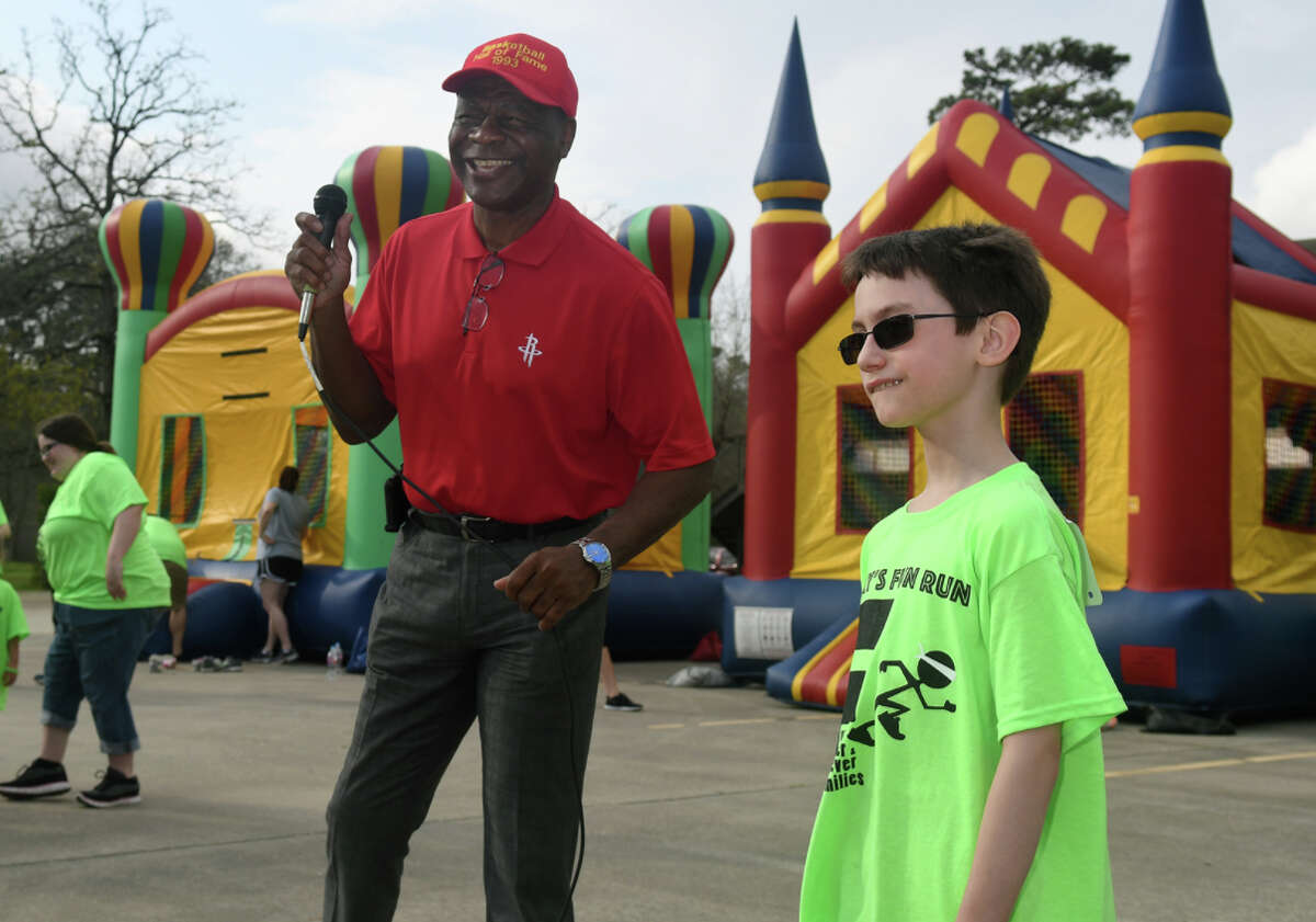 Former Houston Rocket Calvin Murphy, left, shares a laugh with Timmy Schultz, 8, a 3rd grader at Ben Branch Elem. in New Caney, before the start of the annual "Timmy's Adoption Fun Run" at Kingwood United Methodist Church on March 4, 2018. (Photo by Jerry Baker/Freelance)