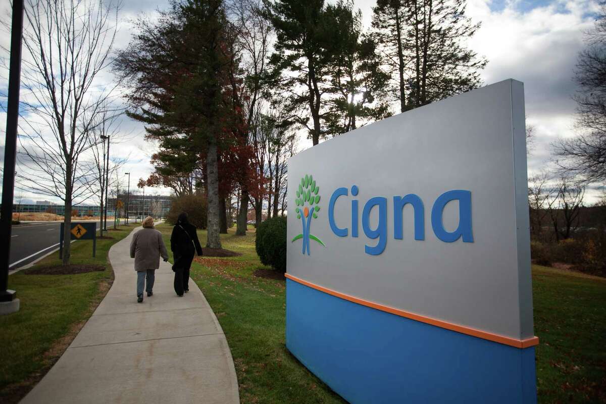 Pedestrians pass Cigna headquarters in Bloomfield, Connecticut, on Nov. 22, 2016.