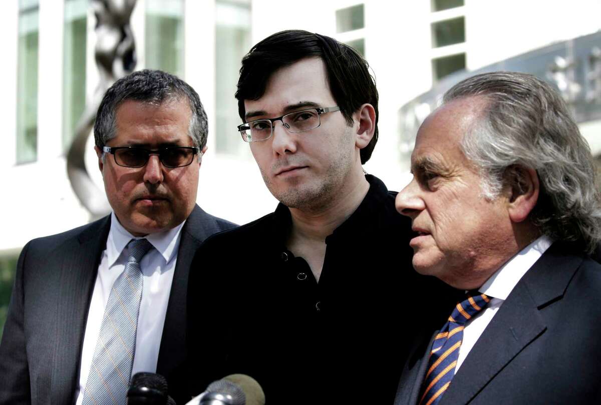 Martin Shkreli, former chief executive officer of Turing Pharmaceuticals, center, listens while his attorney Benjamin Brafman, right, speak to members of the media outside federal court in the Brooklyn borough of New York in August.