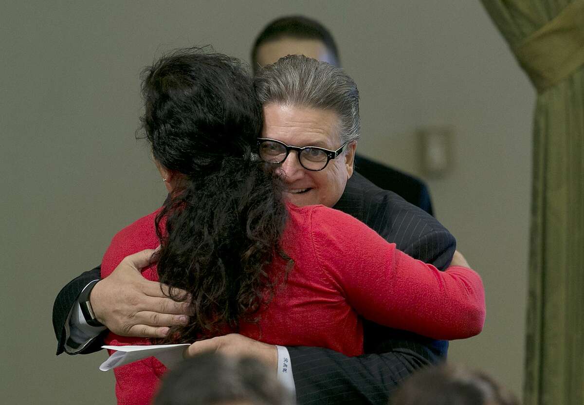 FILE - In this Aug. 31, 2017 file photo, State Sen. Bob Hertzberg, D-Van Nuys, hugs Assemblywoman Lorena Gonzalez Fletcher, D-San Diego, after his storm water bill was approved by the Assembly in Sacramento, Calif. Hertzberg has been told to stop hugging people after a sexual misconduct investigation concluded his behavior made multiple colleagues uncomfortable. Hertzberg was formally reprimanded Tuesday, March 6, 2018, by the Senate Rules Committee. The Los Angeles-area says he will respect the request not to hug people. (AP Photo/Rich Pedroncelli, File)