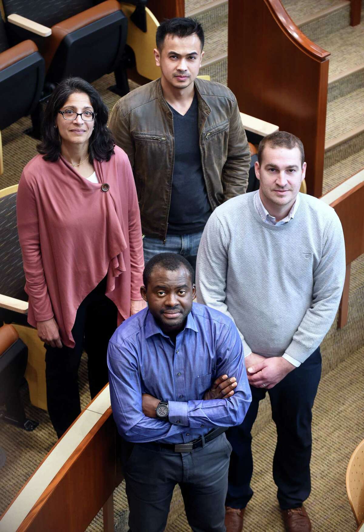 Toto Kisaku, front, of the Democratic Republic of Congo, with, from left, QuinnipiacLaw professor Sheila Hayre and law students Thai Chhay and Brendan Lawless.