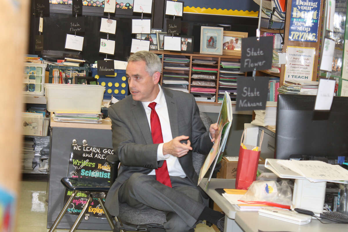 Madison County State's Attorney Tom Gibbons reads "Wordy Birdy" during the Read Across America event Thursday at Woodland Elementary School.
