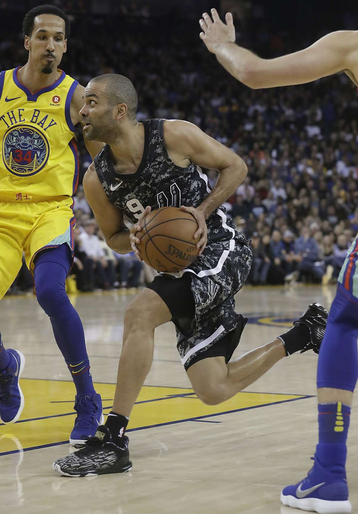San Antonio Spurs guard Tony Parker (9) drives against the Golden State Warriors during the second half of an NBA basketball game in Oakland, Calif., Thursday, March 8, 2018. (AP Photo/Jeff Chiu)