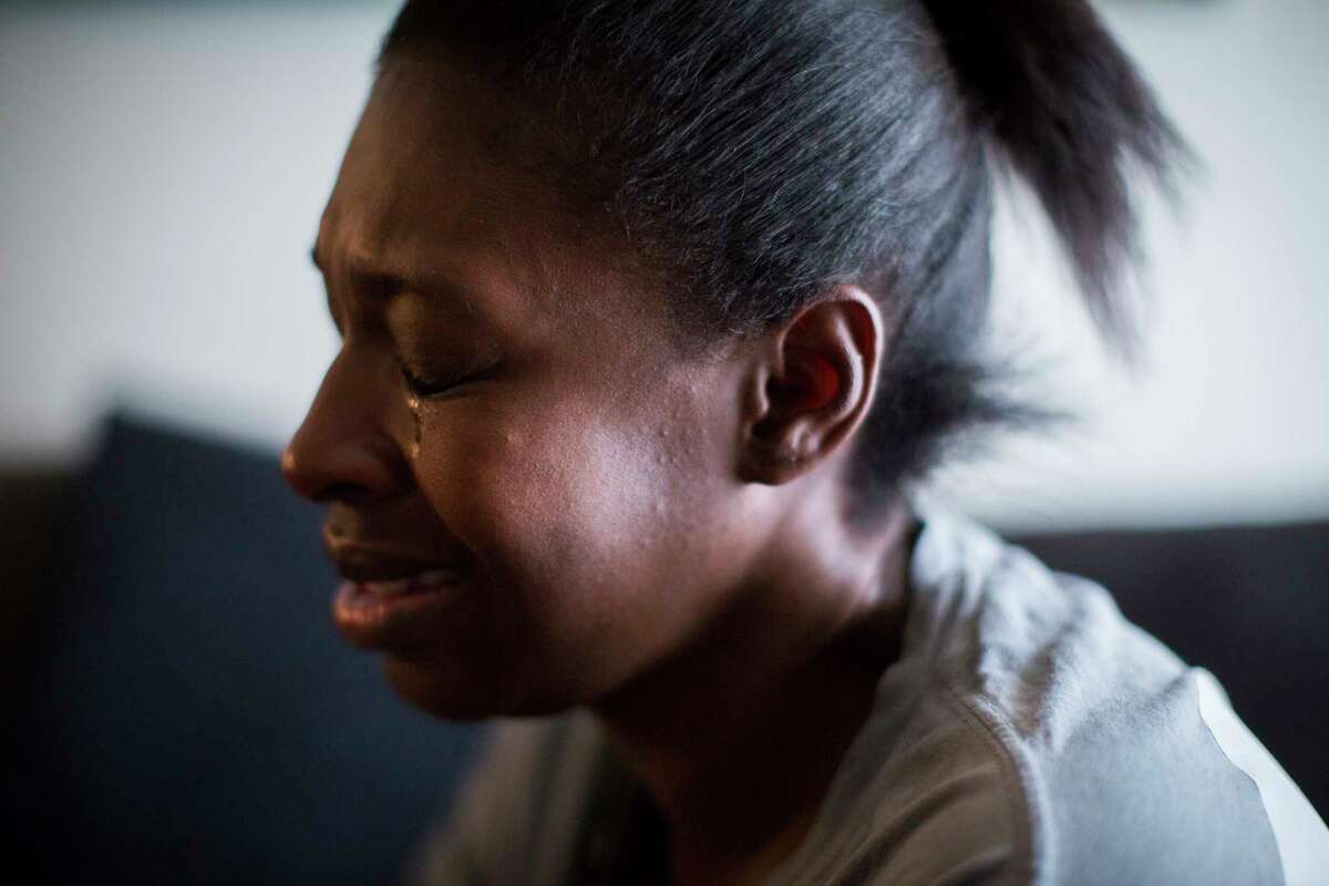 Joyel McCardell cries for her son Justin Gooden, a 6-year old boy who unintentionally shot himself with a gun he found in a bedroom at his sister's apartment. Tuesday, Feb. 13, 2018, in Houston.