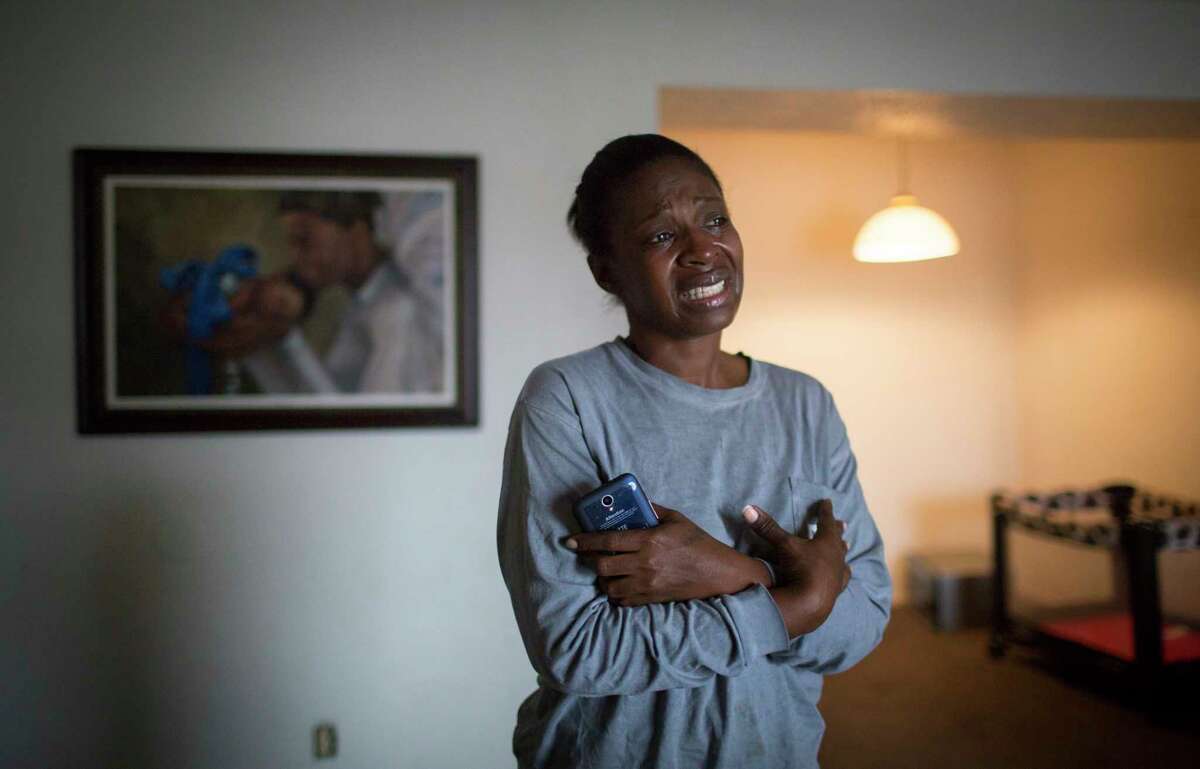Joyel McCardell cries for her son Justin Gooden, a six-year-old boy that unintentionally shot himself with a gun he found in a bedroom at his sister's apartment. Tuesday, Feb. 13, 2018, in Houston.