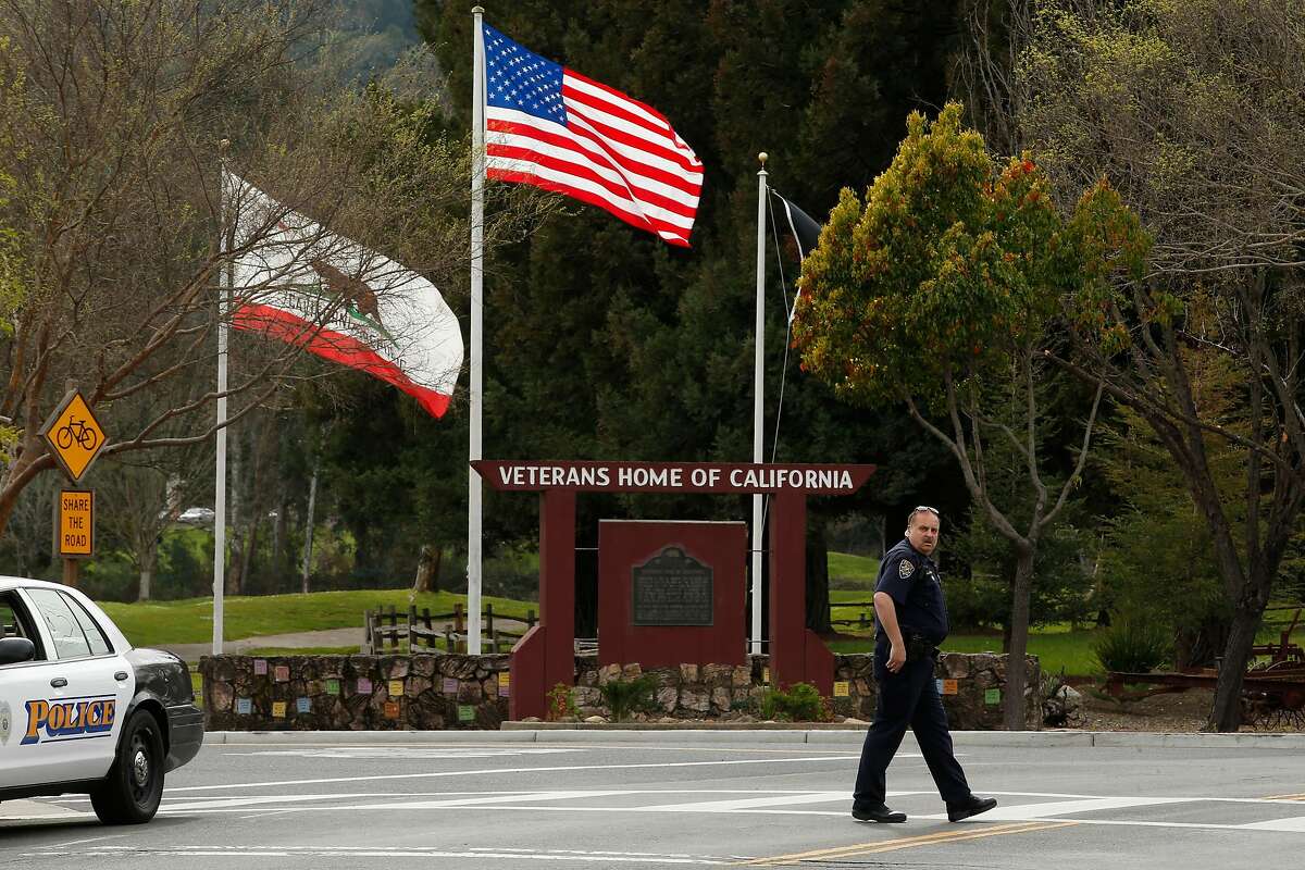Jeff Hullquist, the Chief of Police of the Napa Valley Railroad Police Department, stands guard and leads motorists away from the Veterans Home of California during an ongoing hostage situation, Friday, March 9, 2018, in Yountville, Calif.