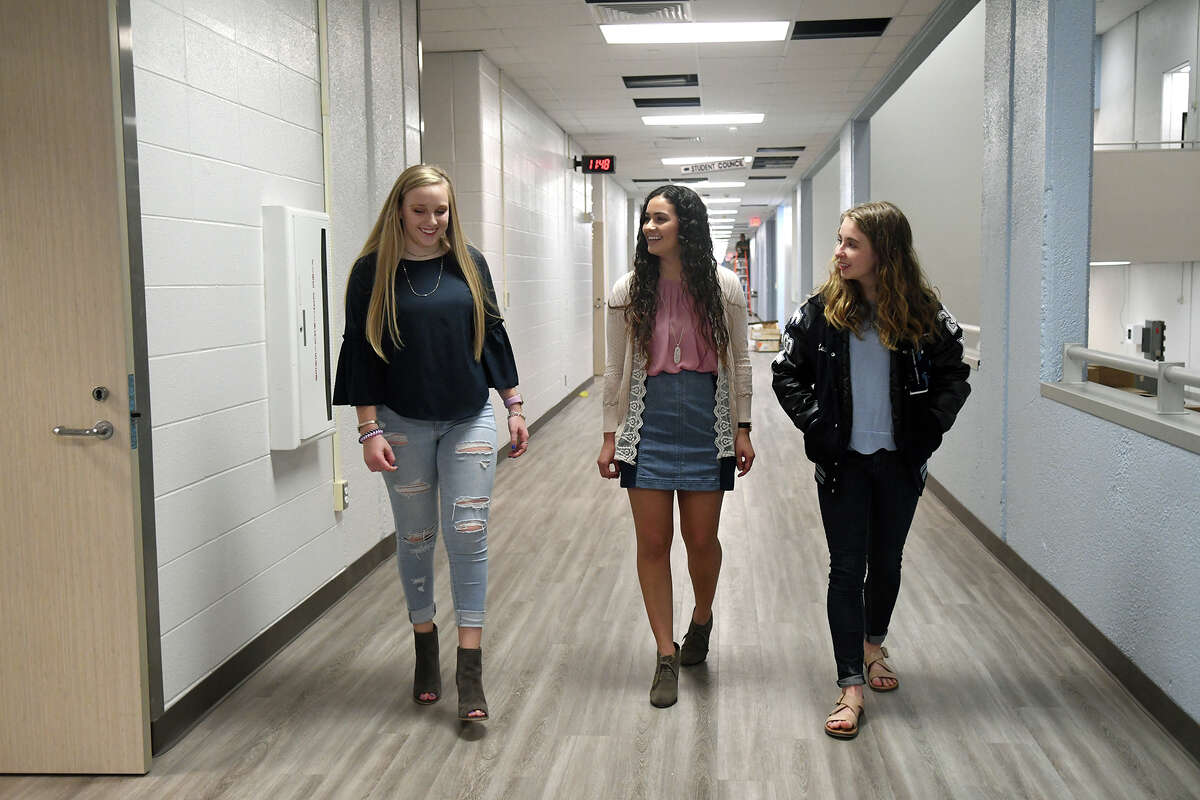 Kingwood High School juniors Abigail McCollum, 16, from left, and Co-KHS 2018-2019 Student Body Presidents Marissa Amar, 17, and Leah Sanders, 16, check out one of the refinished hallways at the school during media interviews and tours held to publicize the March 19 school reopening held on March 9, 2018. (Photo by Jerry Baker/Freelance)