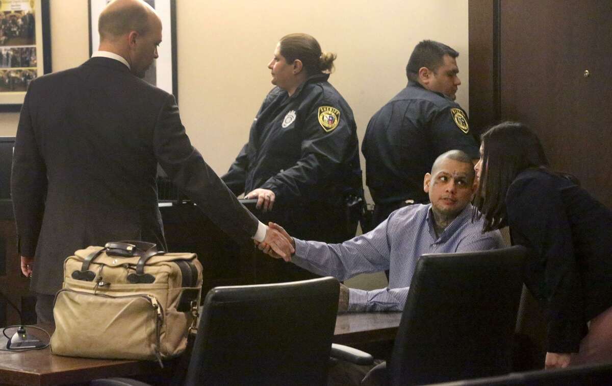 Gabriel Moreno (second from right, seated speaks to one of his defense attorneys, Kelly Feicht (right), Friday, March 9, 2018 in the 379th state District Court after a mistrial was declared by Judge Ron Rangel. On the left shaking Moreno’s hand is defense attorney Albert Gutierrez Jr.