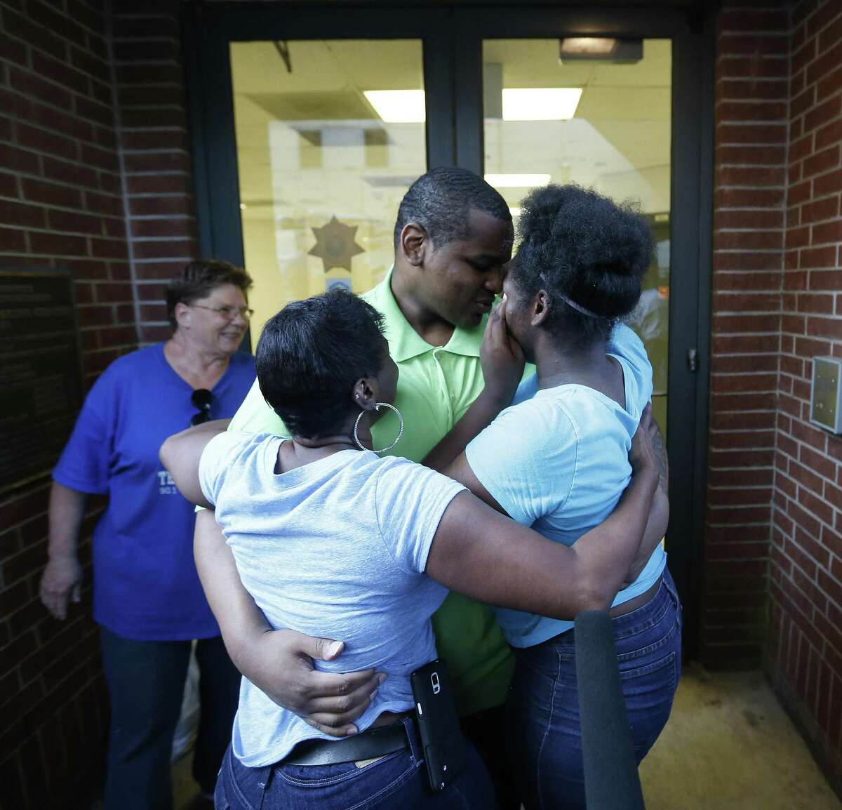 Alfred Brown walks out of the Harris County Jail and into the arms of his sister Connie Brown, left, and daughter Kierra Brown, 15, right on Monday, June 8, 2015, in Houston.