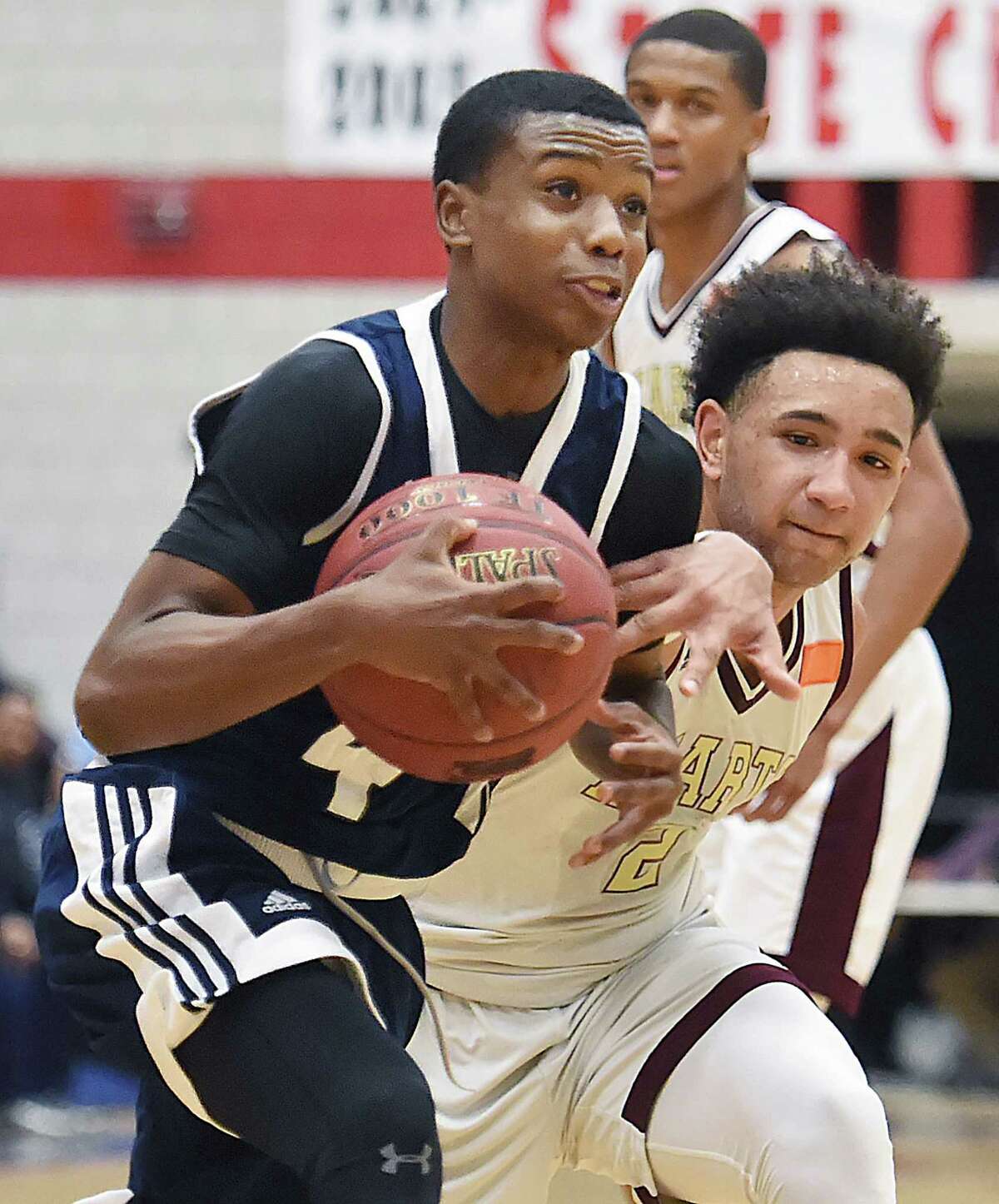 Hillhouse sophomore Tazhon Daniels moves to the hoop as Sacred Heart-Waterbury senior Isiah Gaiter defends, Friday, March 9, 2018, in the CIAC Division 1 second-round game at the Crosby Palace at Crosby High School in Waterbury. Sacred Heart won, 69-58.