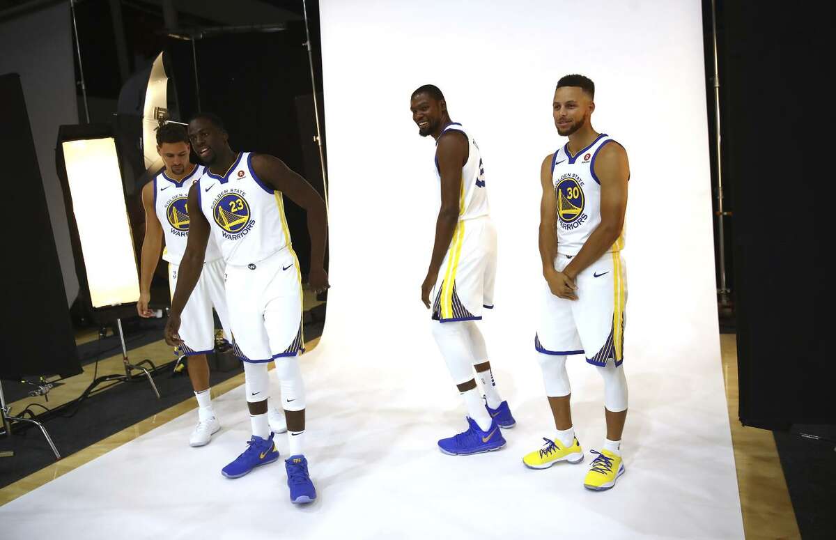 Stephen Curry #30, Kevin Durant #35, Draymond Green #23, and Klay Thompson #11 of the Golden State Warriors pose for a picture during the Golden States Warriors media day at Rakuten Performance Center on September 22, 2017 in Oakland, California.