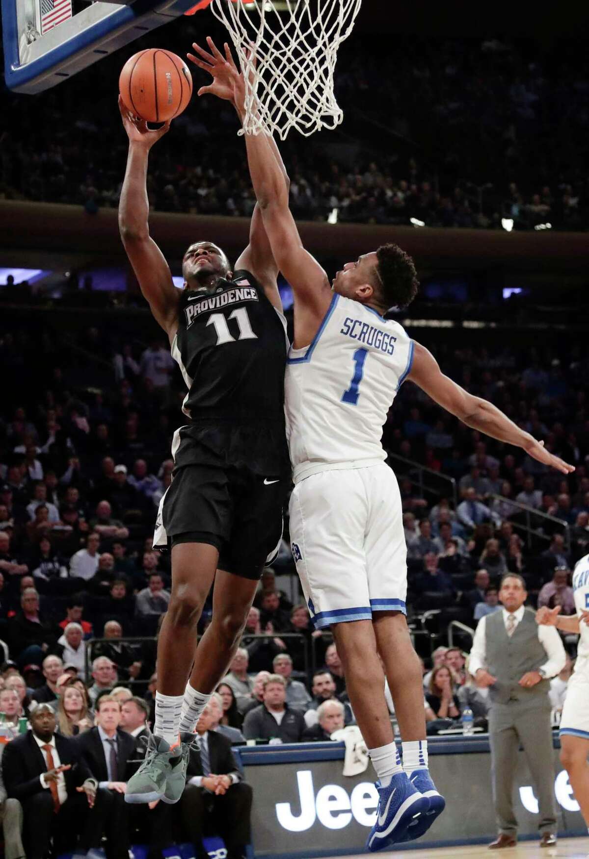 Xavier's Paul Scruggs (1) defends Providence's Alpha Diallo (11) during the second half of an NCAA college basketball game in the Big East men's tournament semifinals Friday, March 9, 2018, in New York. (AP Photo/Frank Franklin II)