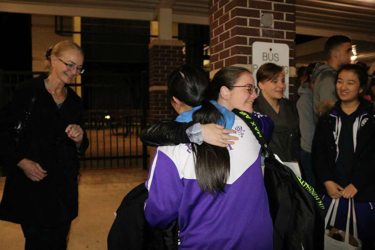 La Porte High School student Christina Longoria gives a welcoming hug to her Nankai High School buddy, Li Xin, as the visitors get off the bus from the airport. At left is Christinaâs mother, Elizabeth Baker. At right are LPHS students Marlo Schatz and her buddy, Liu Changyu. The 24 Nankai High School students and their two teachers arrived in La Porte on Jan. 29.