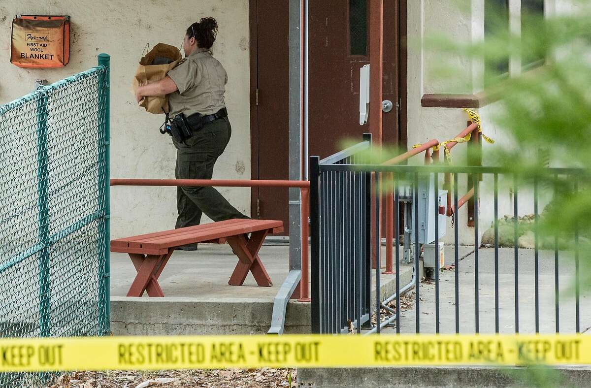 A sheriff's deputy carries out items from inside Pathway Home following the deadly shooting of three female Pathway employees by a former resident at Yountville Veterans Home of California Saturday, March 10, 2018 in Yountville, Calif.