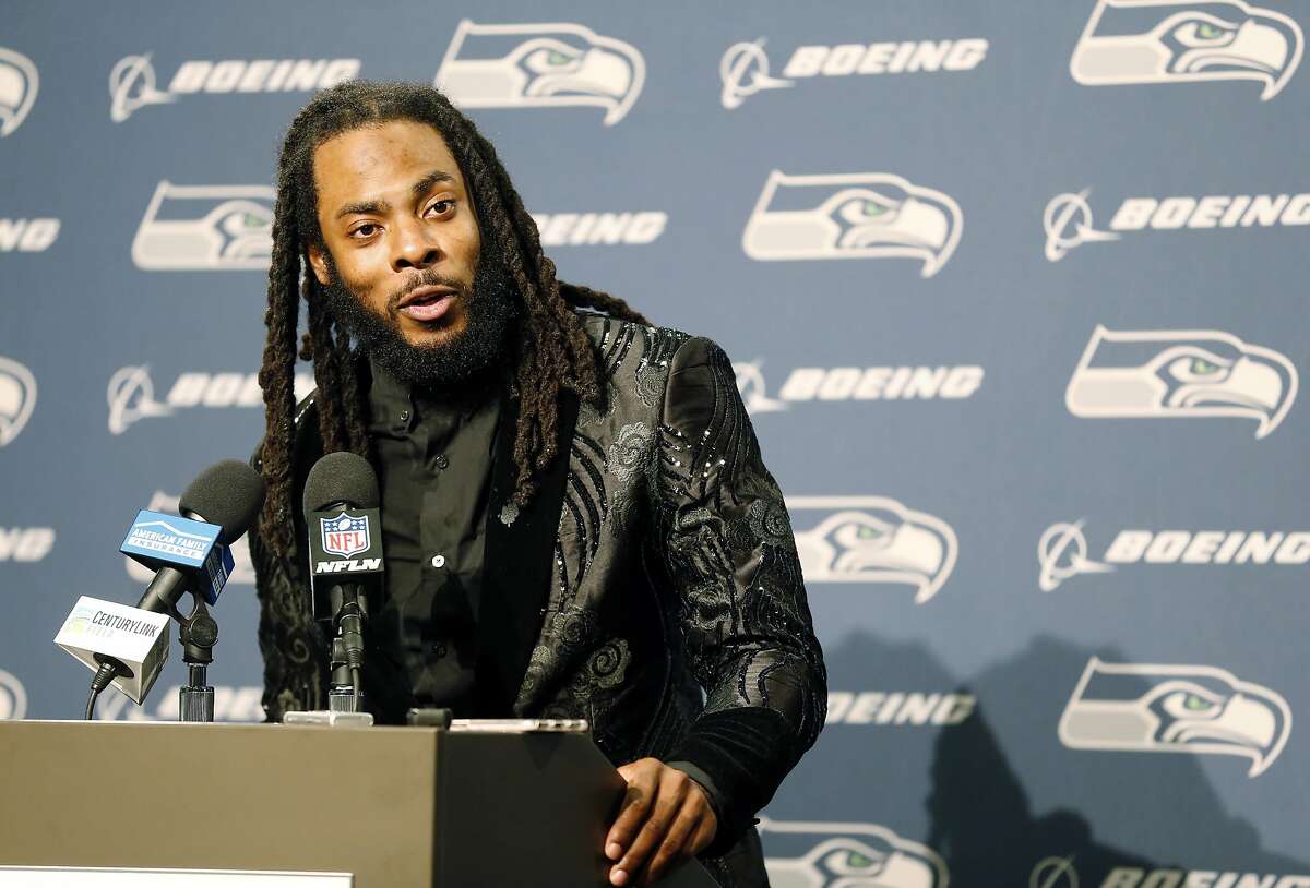FILE - In this Oct. 29, 2017, file photo, Seattle Seahawks cornerback Richard Sherman talks to reporters during a post-game press conference following an NFL football game against the Houston Texans, in Seattle. The Seahawks are cutting ties with star cornerback Richard Sherman after seven seasons. The team has informed him that he will be released, and Sherman confirmed the decision in a text message to The Associated Press on Friday, March 9, 2018. (AP Photo/Stephen Brashear, File)