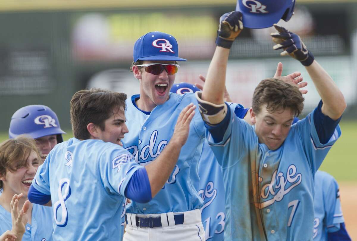 Oak Ridge players celebrate with designated hitter James Starnes, right, after his solo home run in the sixth inning of a game during the Wings 'N More Classic, Saturday, March 10, 2018, in Shenandoah.