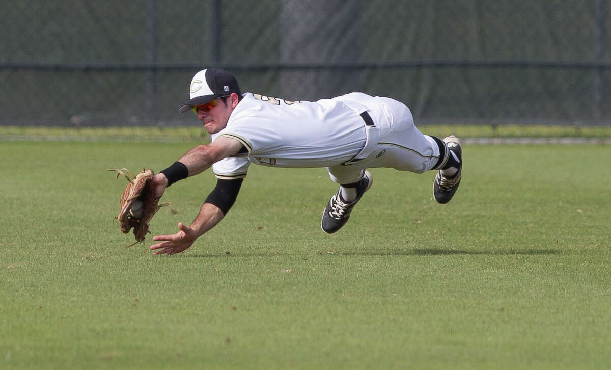 Conroe left fielder Charles Dinaso (5) makes a diving play on Tomball Memorial Alex Quarfordt's line drive in the first inning of a game during the Klein Tomball Tournament, Saturday, March 10, 2018, in Tomball.