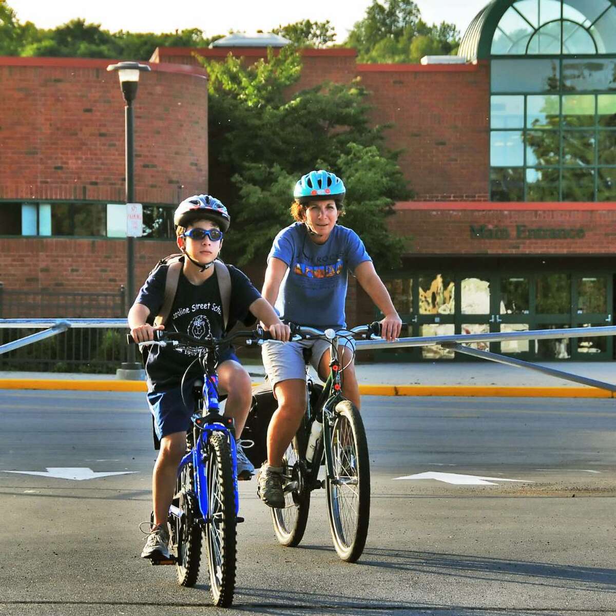 Student Adam Marino, left, 12, rides his bike home from school Thursday afternoon Sept. 24, 2009, accompanied by his mother, Janette Kaddo Marino. (John Carl D'Annibale / Times Union)