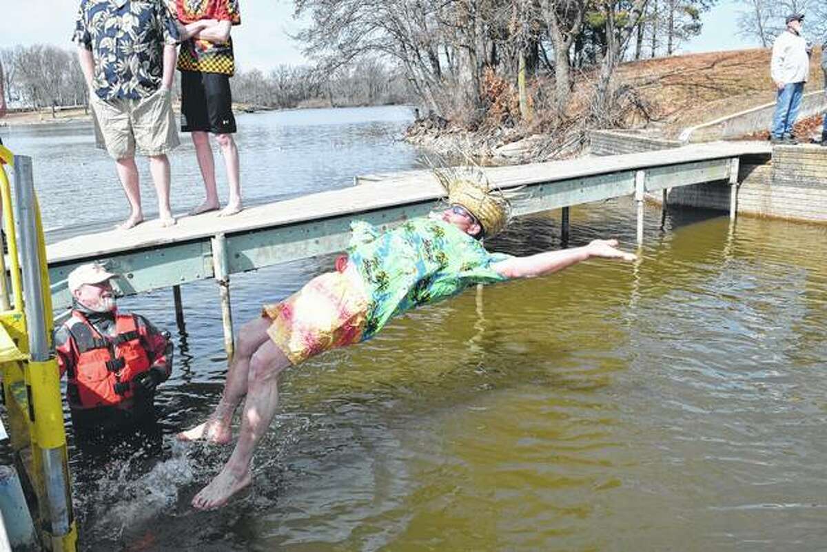 Cameron Turner of Jacksonville falls back into the 45-degree waters of Lake Jacksonville Saturday during Hobby Horse House of Jacksonville’s Polar Plunge, a fundraiser for the child welfare agency. At left is Bruce Selway, a member of the Jacksonville/Morgan County Underwater Search and Rescue Dive Team.