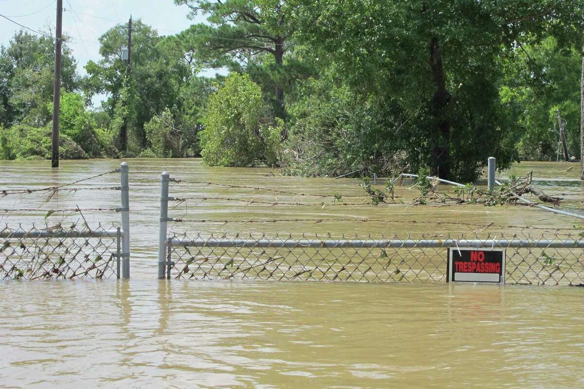 FILE - In this Aug. 31, 2017 file photo, a barbed-wire fence encircles the Highlands Acid Pit that was flooded by water from the nearby San Jacinto River as a result from Harvey in Highlands, Texas. Floodwaters have inundated at least five highly contaminated toxic waste sites near Houston, raising concerns that the pollution there might spread. (AP Photo/Jason Dearen)