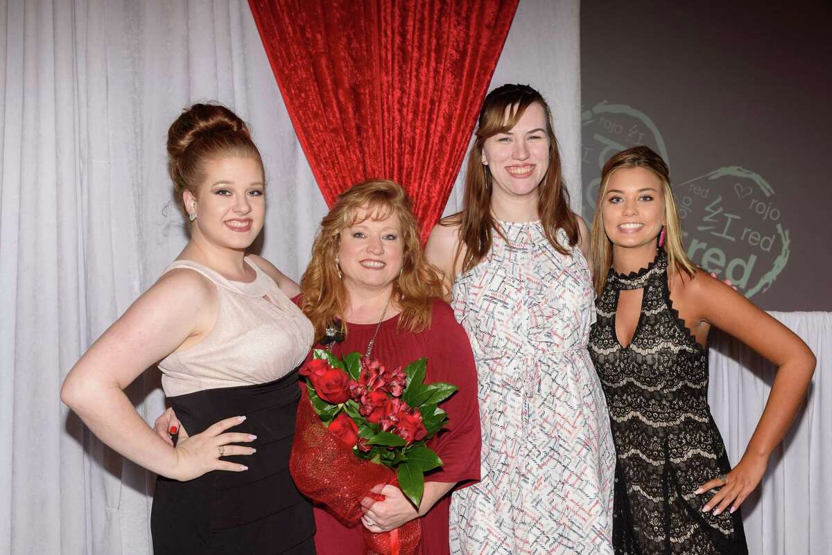 Heart attack survivor Debbie Robinson, second from left, joins her daughters at the American Heart AssociationÂ?’s Bay Area Go Red For Women Luncheon Feb. 23. Â?“I knew the symptoms, but it still happened to me, and it happened at work,Â?” Robinson told the crowd of more than 400 at South Shore Harbour Resort & Conference Center.