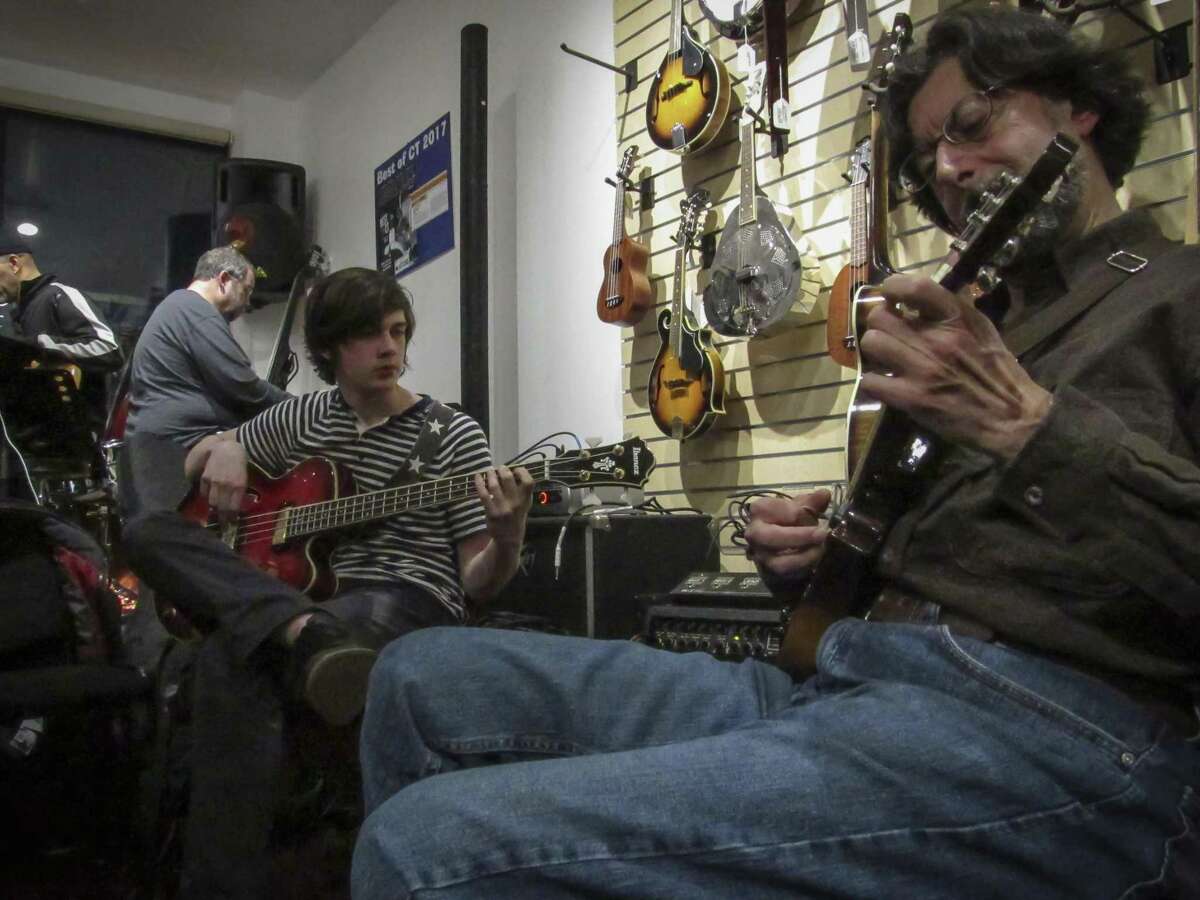 James Rafferty, a high school student, playing bass and Tom Stio on electric mandolin perform during the March 6 open mic jam session at Banko’s 360 East Main Street in Ansonia