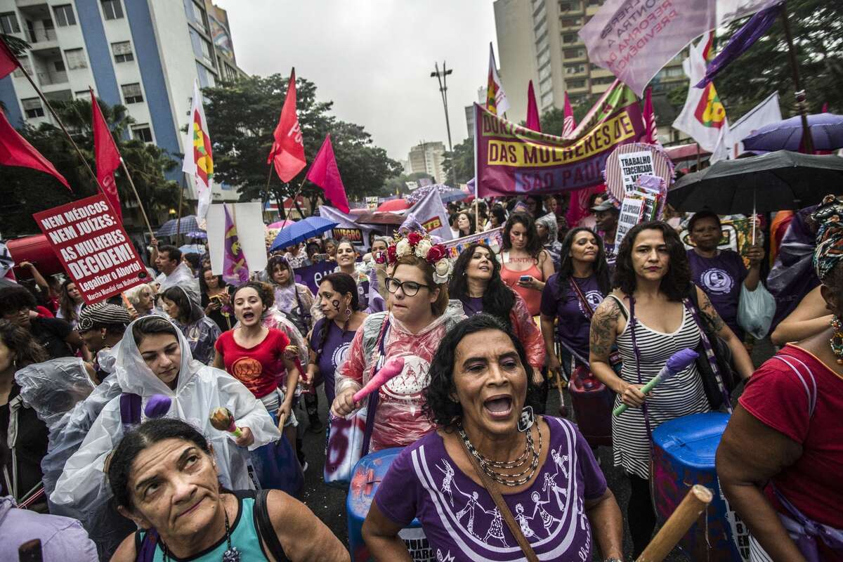 A Brazilian woman wears an earring reading 'Temer out' as she takes part in the commemoration of the International Women's Day in Sao Paulo Brazil on March 8 2018. The International Women's Day is marked worldwide with rallies and strikes.