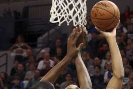 Minnesota Timberwolves' Taj Gibson, right, lays up as Golden State Warriors' Kevin Durant defends in the first half of an NBA basketball game Sunday, March 11, 2018, in Minneapolis. (AP Photo/Jim Mone)